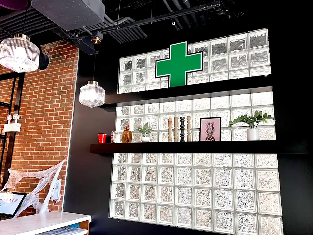 Lit up cannabis LED window sign inside a downtown Chicago dispensary