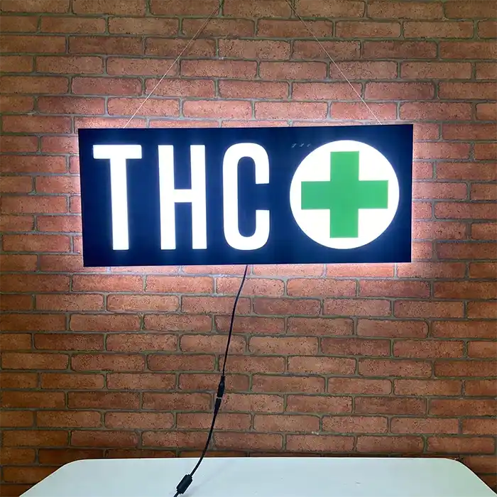 Illuminated THC Sign with a green cross for dispensaries, hemp shops and marijuana stores