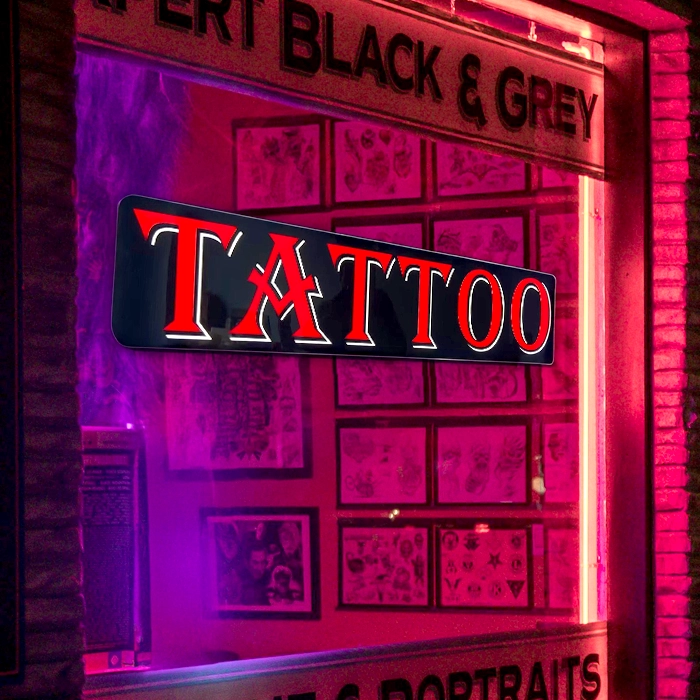 closeup Tattoo LED window sign brightly lit at night