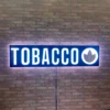 Smoke shop Tobacco LED Retail ready sign against a red brick wall