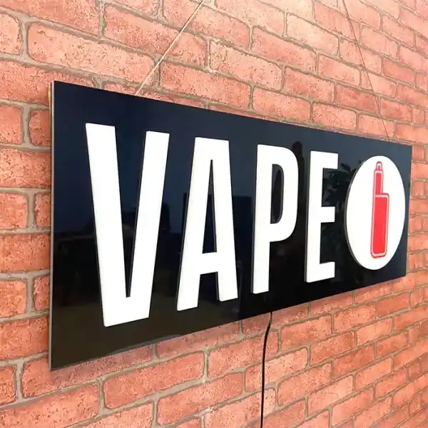 VAPE Led sign on a red brick wall