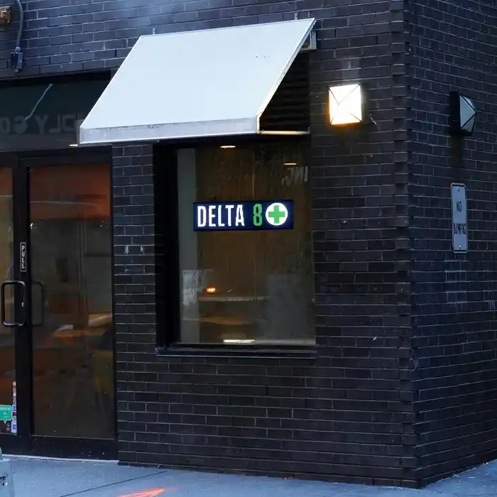 Close-up of a Delta 8 shop sign LED in a store window