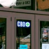 CBD Smoke Shop LED Sign hung on dispensary door